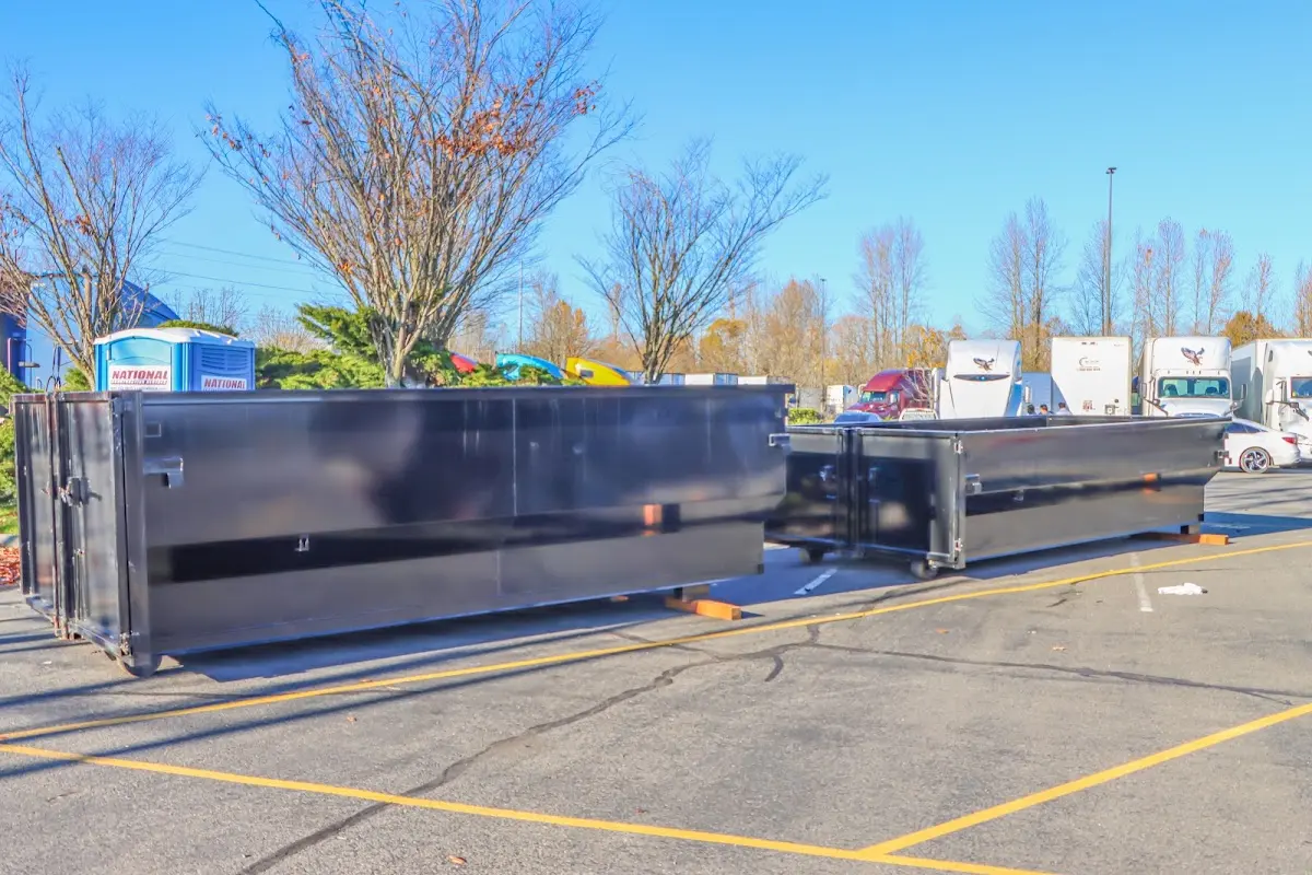 Professional dumpster rental service with roll-off container on residential driveway in Olive